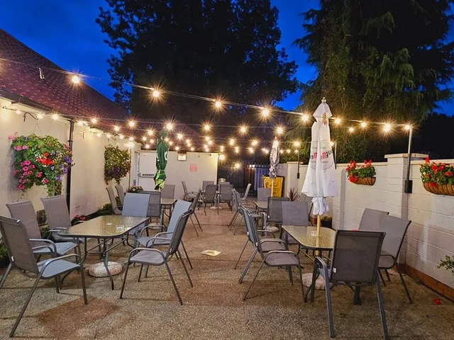 The beer garden at dusk with festoon lighting